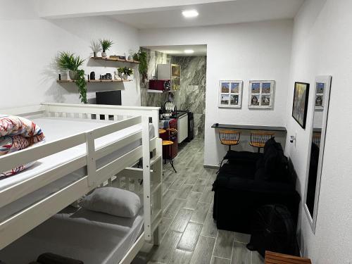 a bedroom with a bunk bed and a desk at Meu Loft Barra Nova 3 in Saquarema