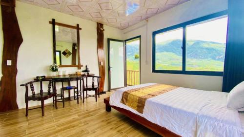 a bedroom with a bed and a desk and a table at Hà Lù Homestay in Lao Cai
