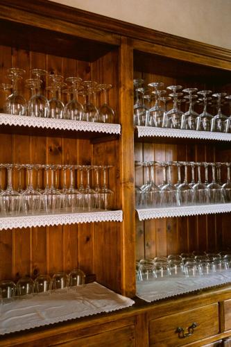 a cabinet filled with lots of wine glasses at Villa Delia Hotel and Cooking School in Ripoli