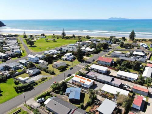 an aerial view of a town near the ocean at Another on Leo in Waihi Beach
