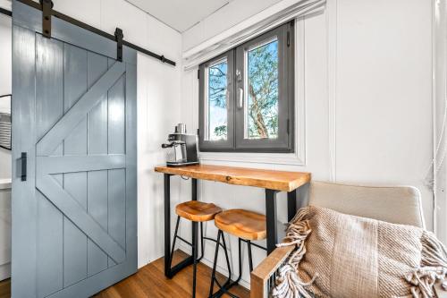 a small kitchen with a table next to a door at Tiny Home - Redbird in Hartley