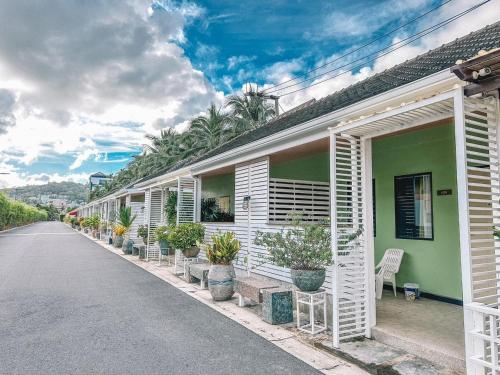 a row of houses with plants on the side of the road at Favorite Place in Kata Beach