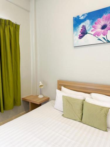 a bedroom with a bed and a green curtain at Favorite Place in Kata Beach