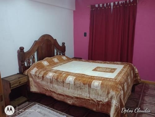 a bedroom with a bed and purple walls at ALDAO in Malargüe