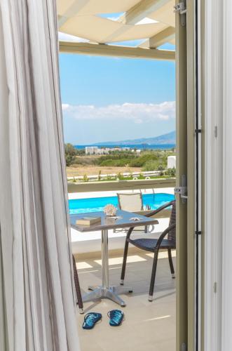 a view from the balcony of a villa with a table and chairs at Sea & Olives Suites Hotel and Villas in Plaka