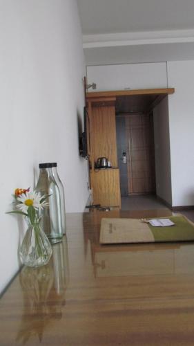 a room with a table with flowers in a vase at Mountain Retreat Kodai in Kodaikānāl