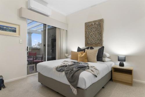 a bedroom with a large bed and a window at Riverside Panorama Suite Spectacular City Living in Perth