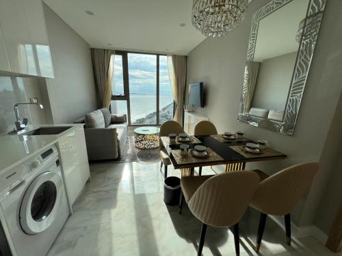 a kitchen and living room with a washing machine at Copacabana Jomtien Beach Condo 中天海滩寇芭酒店公寓 in Jomtien Beach