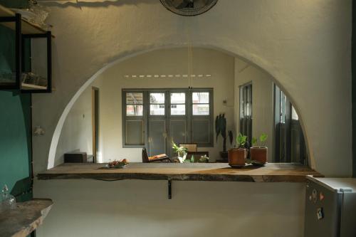 a kitchen with an archway in the middle of a room at Ranasa Yogyakarta in Timuran