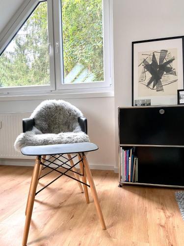 a chair with a furry pillow on it in a room at Harzpur Lodge - Pure Entspannung in purer Natur in Hahnenklee-Bockswiese