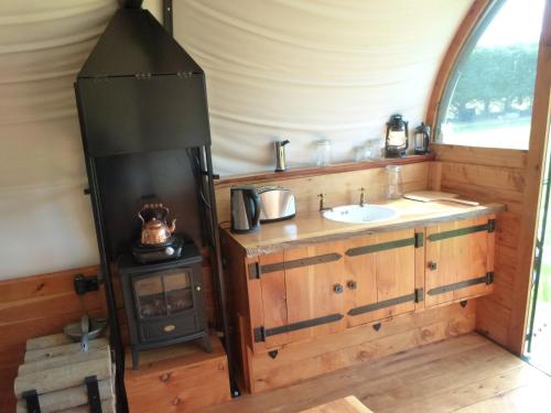 a bathroom with a sink and a stove in a tent at Wacky Stays - unique farm-stay glamping rentals, FREE animal feeding tours in Kaikoura