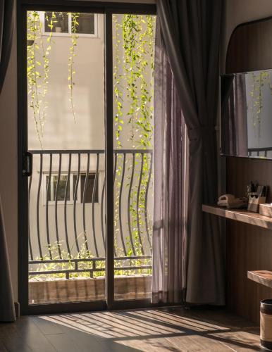 a room with a door open to a balcony at Aaron Boutique Hotel in Nha Trang