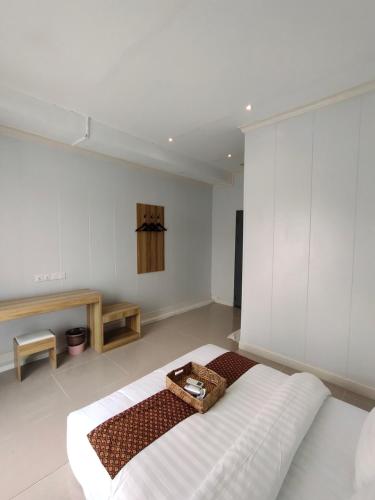 a large white room with a bed in it at Casa Casa in Semporna