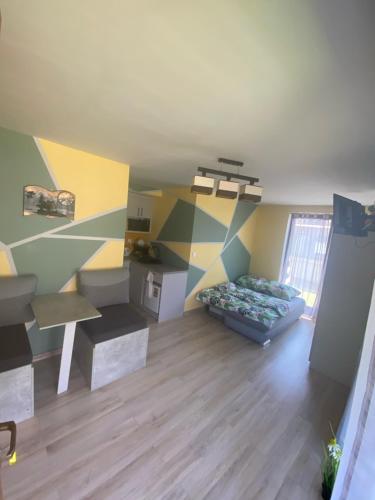 a living room with a bed and a table at Morska Bryza in Chłopy