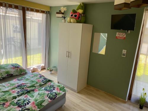 a bedroom with a bed and a tv on a wall at Morska Bryza in Chłopy