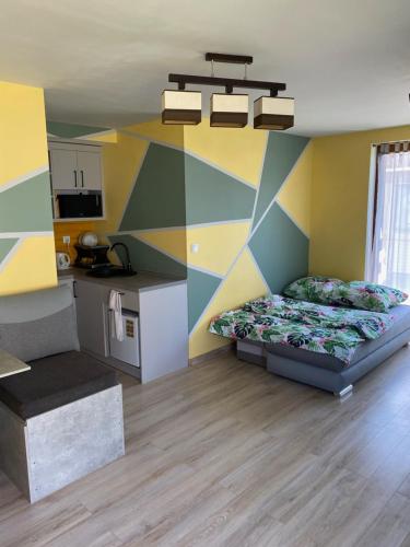 a bedroom with two beds and a colorful wall at Morska Bryza in Chłopy