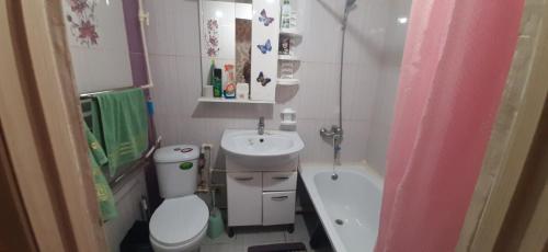 a small bathroom with a toilet and a sink at квартира по Гумарова in Atyrau