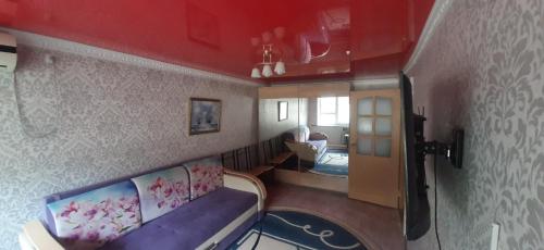 a view of a living room with a couch in a room at квартира по Гумарова in Atyrau