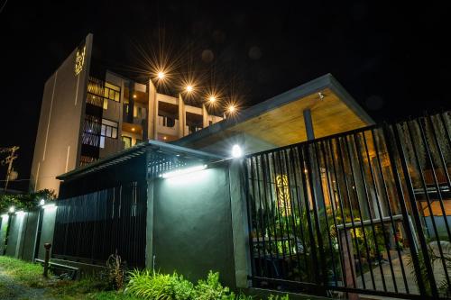 a building with lights on the side of it at night at Guuden Huahin Hotel in Hua Hin