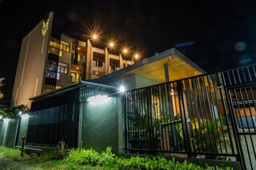 a building with a gate in front of it at night at Guuden Huahin Hotel in Hua Hin