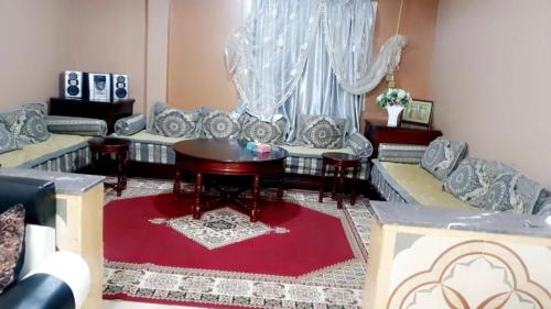 a living room with a couch and a table at شقة فاخرة مجهزة in Marrakesh