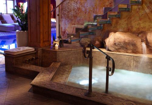 a bath tub in a room with a staircase at Sporthotel Lorünser in Zürs am Arlberg