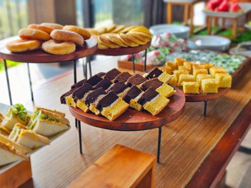 a display of different types of bread and pastries at The Batu Hotel & Villas in Batu