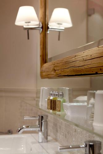 a bathroom with a sink and a mirror at Sporthotel Lorünser in Zürs am Arlberg