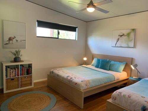 a bedroom with two beds and a window at Panda's Patch Dunsborough in Dunsborough