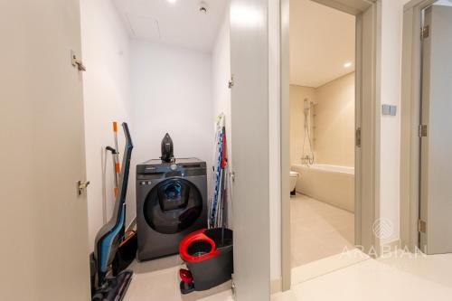 a room with a washing machine in a bathroom at Brand New 2BR Apt with Palm Views and Private Beach - High Floor in Dubai