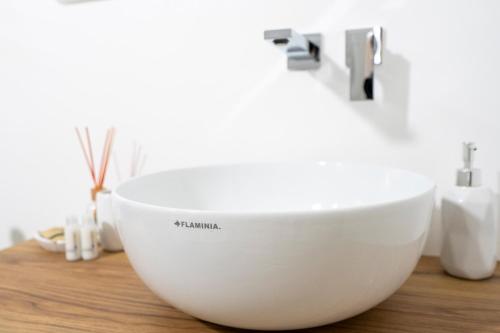a white bowl sitting on a counter in a bathroom at Casa Del Barone - Luxury Suites in Monopoli