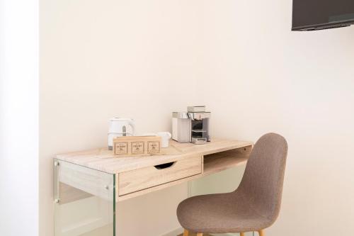 a desk with a chair and a coffee maker on it at Casa Del Barone - Luxury Suites in Monopoli