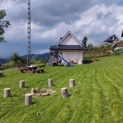 a park with a playground and a house at Cisza i Spokój in Szczawnica