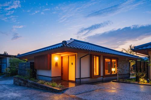 a house with a lit up front yard at 宿坊　心月 in Arita