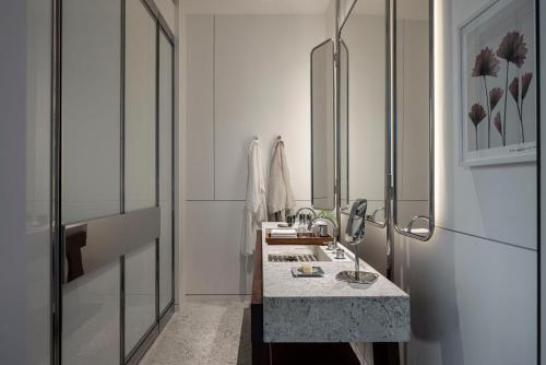 a bathroom with a sink and a mirror at R48 Hotel and Garden in Tel Aviv