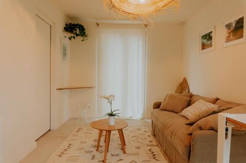 a living room with a couch and a table at Studio Palmito in Bidart