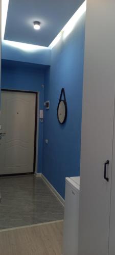 a room with a blue wall and a garage at Aylin apartments 359/3 in Almaty