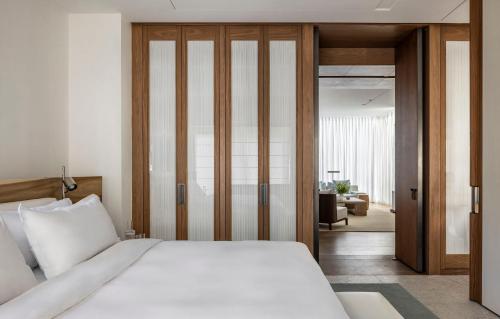 a bedroom with a bed and a sliding glass door at R48 Hotel and Garden in Tel Aviv