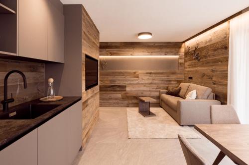 a kitchen and living room with a couch and a table at Obergasserhof Apt Hütten Gaudi in Riscone