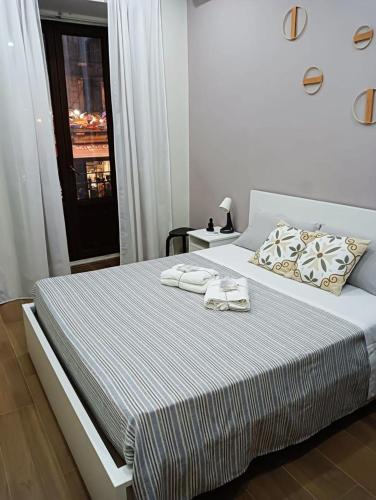 a bedroom with a bed with two towels on it at A piscaria in Catania