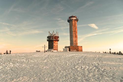 two towers on top of a snow covered field at Hotel Traumblick in Oberhof