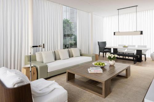 a living room with a couch and a table at R48 Hotel and Garden in Tel Aviv
