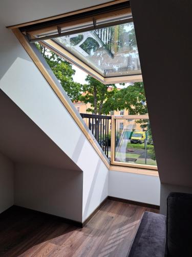 an attic room with a large window in a house at Ösel Residence in Kuressaare