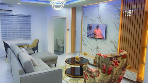 a living room with a couch and a chair at Thistle Greens Apartment in Ikeja