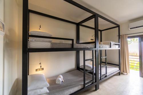 a room with four bunk beds in it at La Joya Farm Resort & Spa in Aloguinsan