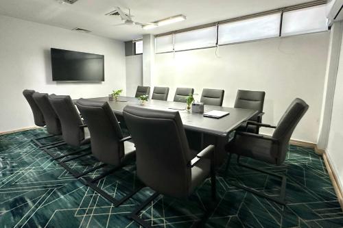a conference room with a long table and chairs at Manhattan Business Hotel, Male in Male City