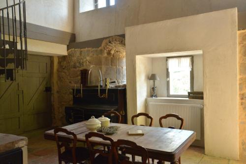 a dining room with a wooden table and chairs at La Maison De Marthe in Malleval