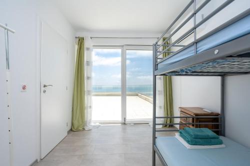 a bedroom with a bunk bed with a view of the ocean at Villa Tatalia, Bozhurets in Bozhurets