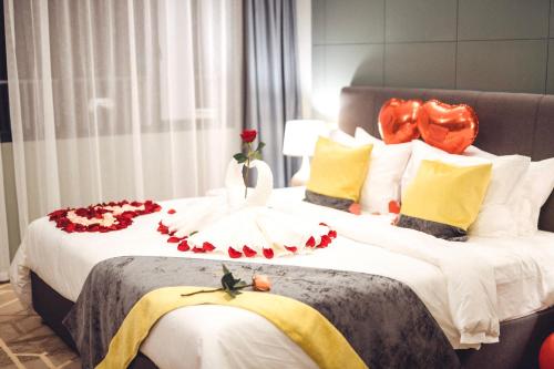 two beds in a hotel room with flowers on them at Manhattan Business Hotel, Male in Male City