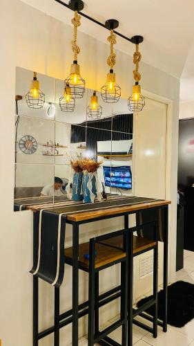 a kitchen with a table with chairs and lights at Casa Cabilao Staycation in Santa Rosa